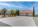 Charming home featuring a three-car garage, desert landscaping, and ample driveway space at 2780 Avenue Of The Stars, Pahrump, NV 89060
