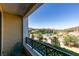Balcony with wrought iron railing overlooking a lake with mountains in the distance at 29 Montelago Blvd # 209, Henderson, NV 89011