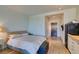 Open floor plan bedroom with wood floors and a view of the entry and kitchen at 29 Montelago Blvd # 209, Henderson, NV 89011