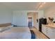 Open floor plan bedroom with wood floors and a view of the entry and kitchen at 29 Montelago Blvd # 209, Henderson, NV 89011