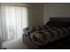 Bedroom with a large window, a bed with dark linens, and neutral carpet at 3550 Bay Sands Dr # 2053, Laughlin, NV 89029