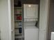 Laundry closet with a stackable washer and dryer, plus shelving for storage at 3550 Bay Sands Dr # 2053, Laughlin, NV 89029