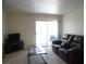 Living room with sliding door to balcony, brown leather sofa and entertainment center at 3550 Bay Sands Dr # 2053, Laughlin, NV 89029