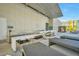 Outdoor kitchen and lounge area with grill, bar seating, and comfortable benches by the pool at 3722 Las Vegas Blvd # 603, Las Vegas, NV 89158