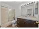 Bathroom with tub/shower, dark vanity, and sliding glass door at 3935 Tirana Way, Las Vegas, NV 89103