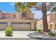 Charming home featuring a two-car garage, mature tree, and well-maintained landscaping at 3935 Tirana Way, Las Vegas, NV 89103
