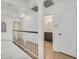 Upstairs hallway boasts white walls, wood floors, and access to bedrooms and bathrooms at 3935 Tirana Way, Las Vegas, NV 89103
