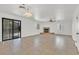 Spacious living room with fireplace, ceiling fan, and sliding glass door at 3935 Tirana Way, Las Vegas, NV 89103