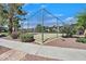 Community tennis court surrounded by landscaping and mature trees for shade at 3935 Tirana Way, Las Vegas, NV 89103