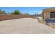 View of the backyard featuring a perimeter wall and low-maintenance desert landscaping at 4011 Scott Russell Ct, North Las Vegas, NV 89031