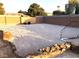 Spacious backyard featuring sand, block wall, rock borders, and a soccer net, ideal for recreational activities at 4011 Scott Russell Ct, North Las Vegas, NV 89031