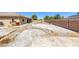 Huge backyard with covered patio, privacy wall, desert landscaping, and a stone walkway at 4011 Scott Russell Ct, North Las Vegas, NV 89031