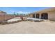 Landscaped backyard has a covered patio, perimeter wall, and desert landscaping at 4011 Scott Russell Ct, North Las Vegas, NV 89031