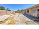 Wide shot of the rear yard with privacy wall, landscaping rocks and low maintenance xeriscaping at 4011 Scott Russell Ct, North Las Vegas, NV 89031
