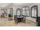 Dining area with wood table, arched windows, and tiled floors at 4011 Scott Russell Ct, North Las Vegas, NV 89031