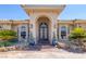 Grand home entrance showcasing arched entryway, iron double doors, and mature landscaping at 4011 Scott Russell Ct, North Las Vegas, NV 89031