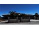 Elegant home exterior featuring decorative wrought iron gate, tile roof, and mature palm trees at 4011 Scott Russell Ct, North Las Vegas, NV 89031