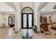 Elegant foyer with tile flooring, a decorative iron door, and arched doorways to other rooms at 4011 Scott Russell Ct, North Las Vegas, NV 89031