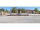 Beautiful desert home featuring an ornate metal security gate, block wall and mature landscaping at 4011 Scott Russell Ct, North Las Vegas, NV 89031