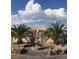 Beautiful front yard featuring palm trees, rock landscaping, and a decorative fountain, enhancing curb appeal at 4011 Scott Russell Ct, North Las Vegas, NV 89031