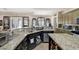 Open-concept kitchen with granite countertops, modern appliances, and a breakfast bar at 4011 Scott Russell Ct, North Las Vegas, NV 89031