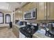 Kitchen features granite counters, stainless appliances, and stone backsplash at 4011 Scott Russell Ct, North Las Vegas, NV 89031