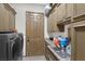 Functional laundry room with modern washer and dryer, ample storage space, and a convenient sink at 4011 Scott Russell Ct, North Las Vegas, NV 89031