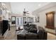 Comfortable living area with leather couches, stone fireplace, and access to the backyard through glass doors at 4011 Scott Russell Ct, North Las Vegas, NV 89031