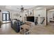 Bright living room with a decorative fireplace, leather sofas, and custom shelving at 4011 Scott Russell Ct, North Las Vegas, NV 89031