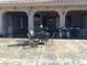 Covered patio with ample seating, grill, and sleek concrete flooring, perfect for outdoor entertaining and relaxation at 4011 Scott Russell Ct, North Las Vegas, NV 89031