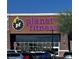 Exterior view of Planet Fitness gym showcasing its purple signage, glass windows, and convenient parking area at 4011 Scott Russell Ct, North Las Vegas, NV 89031