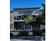 The Ashley Homestore has a neutral facade with large windows, trees, and manicured bushes at 4011 Scott Russell Ct, North Las Vegas, NV 89031