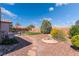 A spacious backyard with lush grass, stone paths, and mature trees, creating a serene and private outdoor retreat at 420 Aloha Dr, Henderson, NV 89015