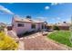 Well-maintained backyard with lawn, desert landscaping, and patio dining set on a concrete patio at 420 Aloha Dr, Henderson, NV 89015