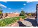 Inviting backyard with well-manicured lawn, mature trees, and outdoor seating on a stone patio, perfect for relaxing at 420 Aloha Dr, Henderson, NV 89015