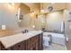 Bathroom featuring a vanity with drawers, marble countertop, mosaic tile floor, and soaking tub at 420 Aloha Dr, Henderson, NV 89015