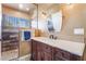 Elegant bathroom featuring wood-style accents, decorative lighting, and a glass-enclosed shower at 420 Aloha Dr, Henderson, NV 89015
