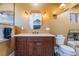Stylish bathroom features a vanity with drawers, a marble countertop, and decorative lighting at 420 Aloha Dr, Henderson, NV 89015