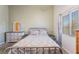 Bedroom with a cozy floral bedspread, a dresser with mirror, and bright natural light at 420 Aloha Dr, Henderson, NV 89015