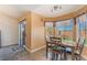 Light and airy dining area with laminate floors, and an open slider to outside at 420 Aloha Dr, Henderson, NV 89015