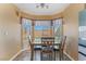 Cozy dining area with natural light, adjacent to kitchen featuring laminate wood flooring at 420 Aloha Dr, Henderson, NV 89015