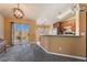 Open concept eat-in kitchen that flows seamlessly into the carpeted dining area at 420 Aloha Dr, Henderson, NV 89015