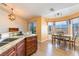 Open-concept kitchen and dining area featuring laminate wood flooring and bright windows at 420 Aloha Dr, Henderson, NV 89015