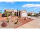 A one-story home with a two-car garage is accentuated by xeric landscaping at 420 Aloha Dr, Henderson, NV 89015