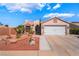 Single-story home featuring well-manicured landscaping and a two-car garage at 420 Aloha Dr, Henderson, NV 89015
