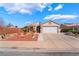 Charming single-story home with a well-manicured desert front yard, and a two car garage at 420 Aloha Dr, Henderson, NV 89015