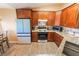 Well-equipped kitchen with wood cabinets, granite counters, and modern stainless steel appliances at 420 Aloha Dr, Henderson, NV 89015