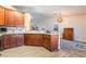 Bright kitchen with wood cabinets, granite counters, stainless steel sink, and recessed lighting at 420 Aloha Dr, Henderson, NV 89015