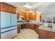 Charming kitchen with wood cabinets, granite counters, new appliances, and tile backsplash at 420 Aloha Dr, Henderson, NV 89015