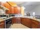 Well-lit kitchen with wood cabinets, granite counters, new appliances, and tile backsplash at 420 Aloha Dr, Henderson, NV 89015